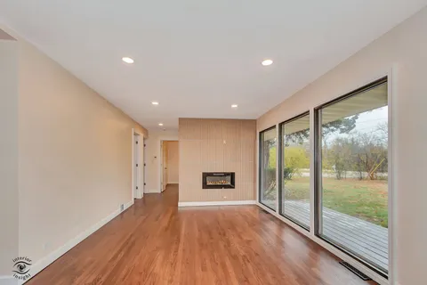 a view of a room with wooden floor and a window