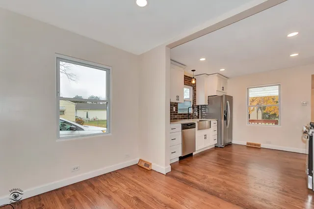 a kitchen with stainless steel appliances a refrigerator sink and stove