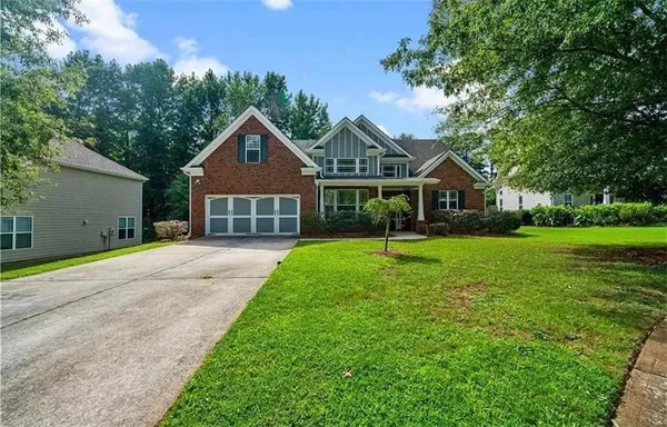 a front view of a house with a yard and garage
