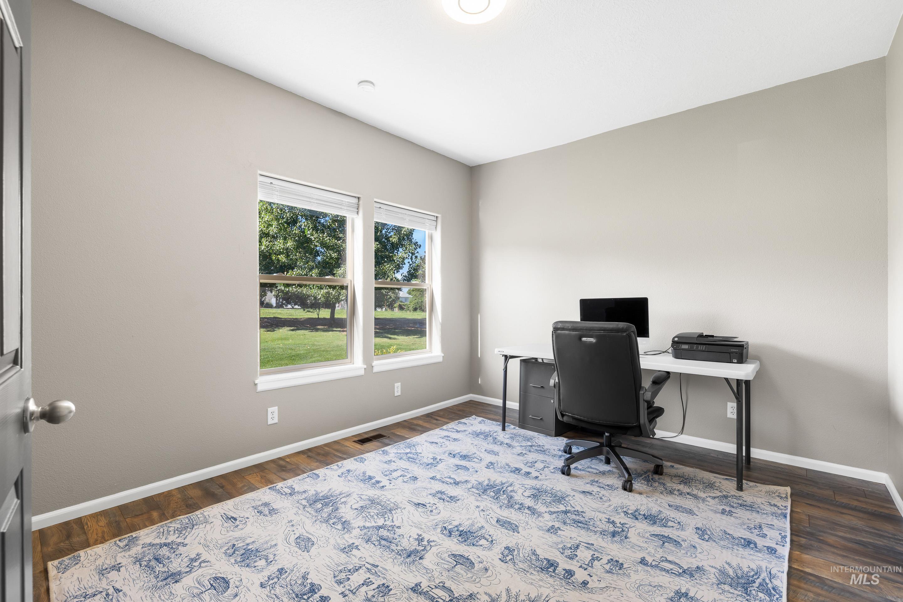 14119 Silver Ridge Road Caldwell, ID 83607 - Photo 26 of 50 Office with baseboards and dark wood-type flooring
