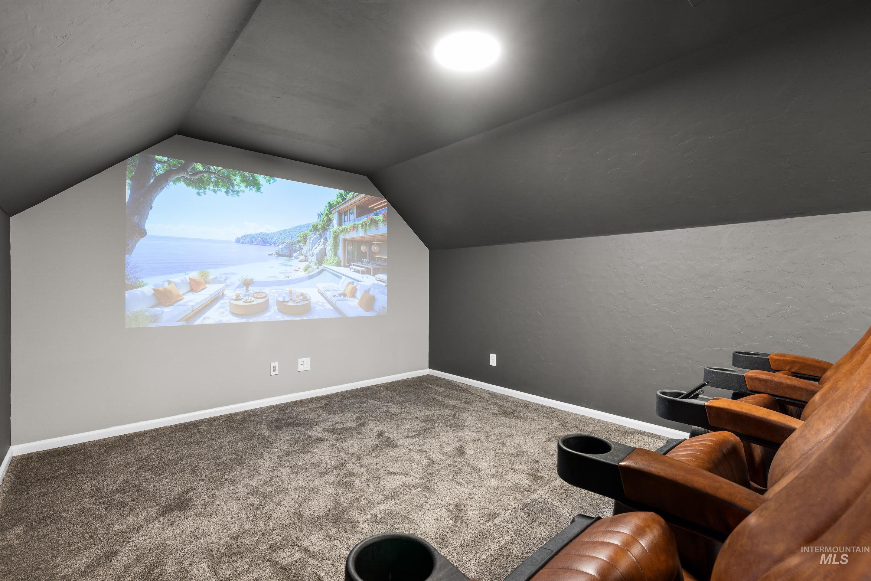 14119 Silver Ridge Road Caldwell, ID 83607 - Photo 36 of 50 Carpeted cinema featuring vaulted ceiling and a textured wall