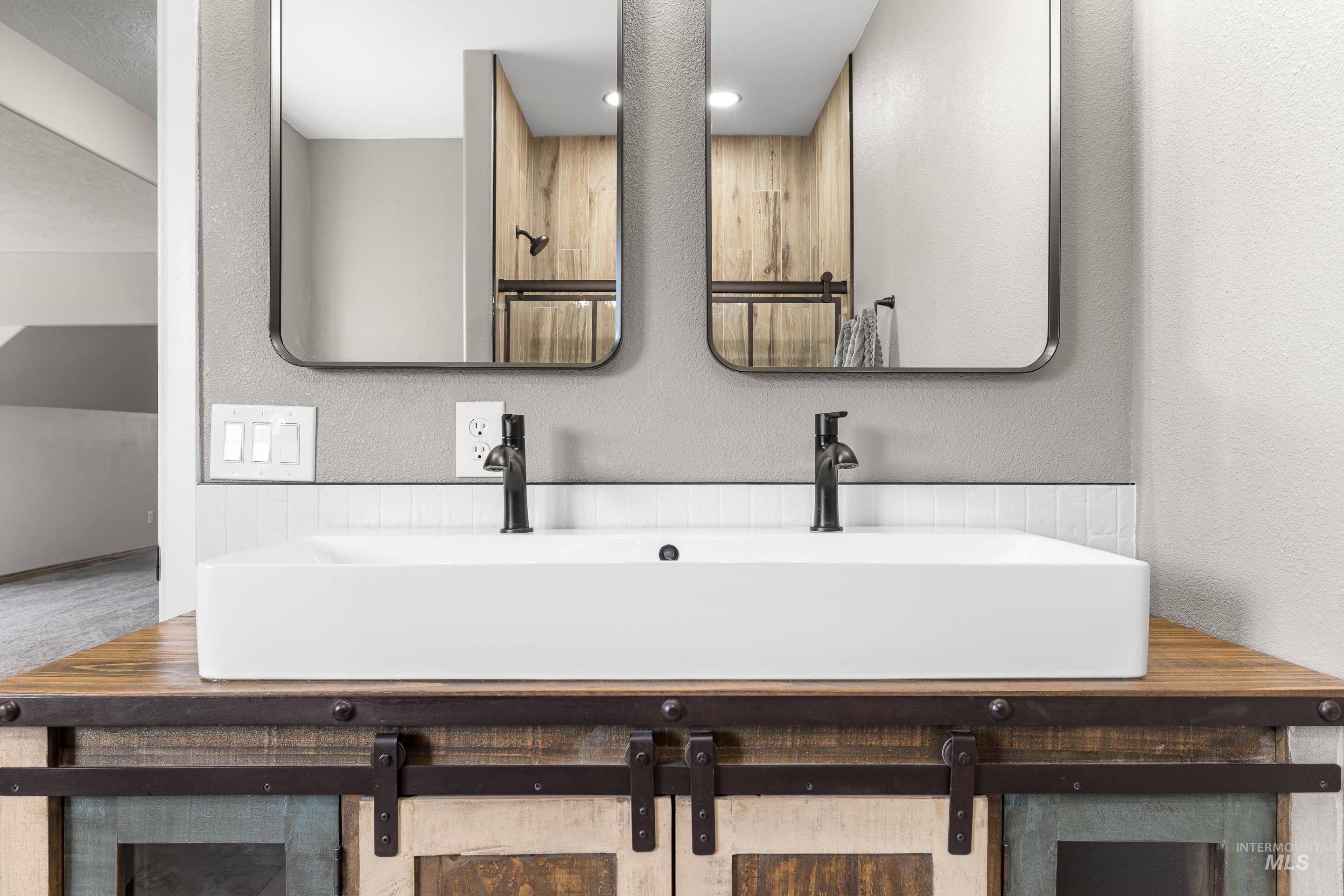14119 Silver Ridge Road Caldwell, ID 83607 - Photo 43 of 50 Full bathroom with a textured wall and double vanity