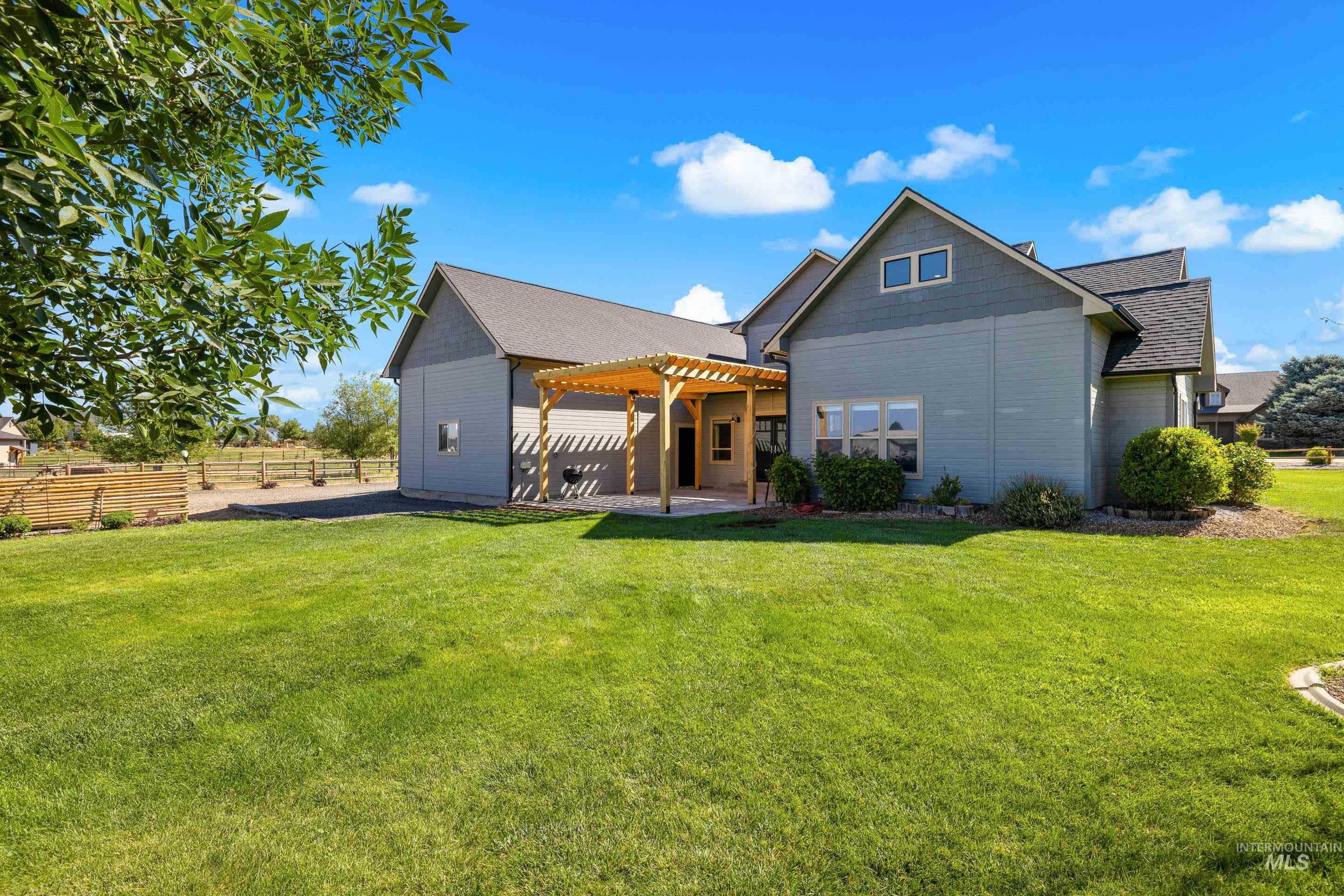 14119 Silver Ridge Road Caldwell, ID 83607 - Photo 46 of 50 Rear view of property featuring a pergola, a patio area, and roof with shingles