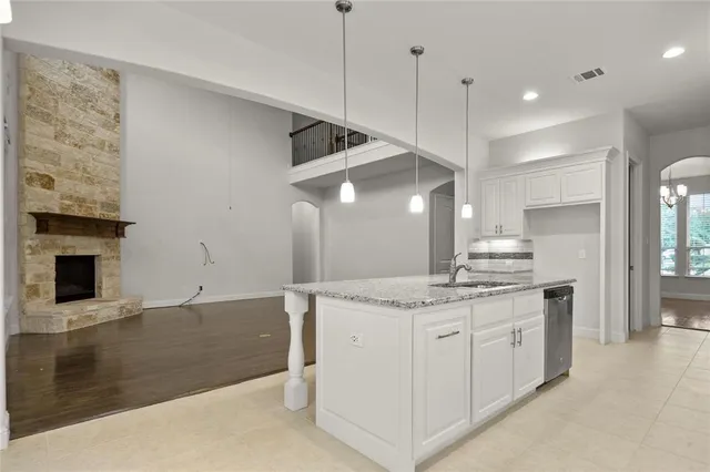 a kitchen with a sink a stove and a refrigerator