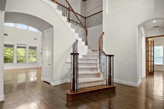 a view of entryway with wooden floor and stairs