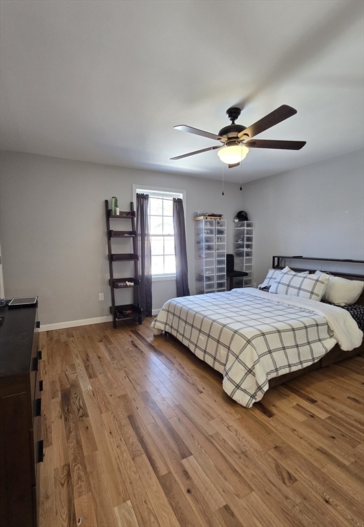 83 Comins Pond Road Warren, MA 01083 - Photo 16 of 29 a bedroom with a large bed and a chandelier