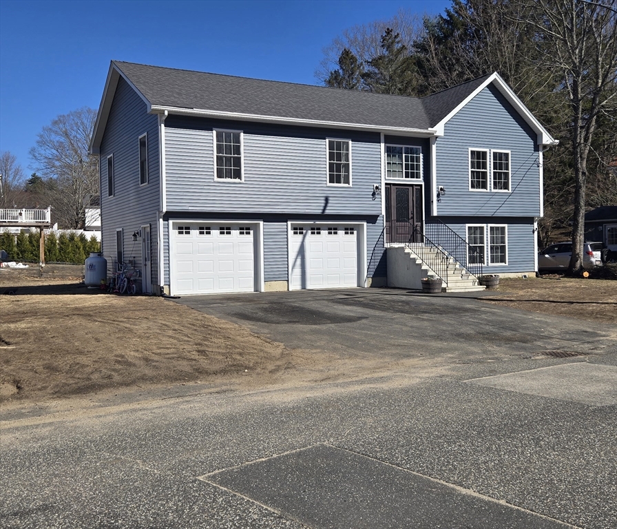 83 Comins Pond Road Warren, MA 01083 - Photo 2 of 29 a front view of a house with a outdoor space
