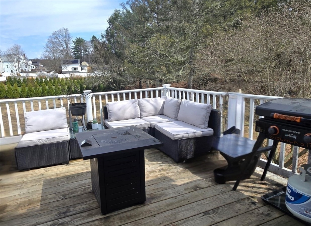 83 Comins Pond Road Warren, MA 01083 - Photo 27 of 29 a roof deck with couches and wooden floor
