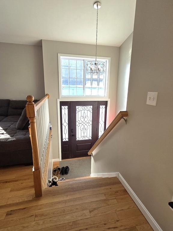 83 Comins Pond Road Warren, MA 01083 - Photo 4 of 29 a view of a livingroom with wooden floor and staircase