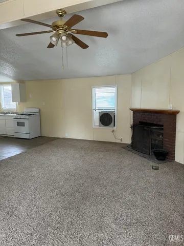 a view of a livingroom with furniture and a fireplace