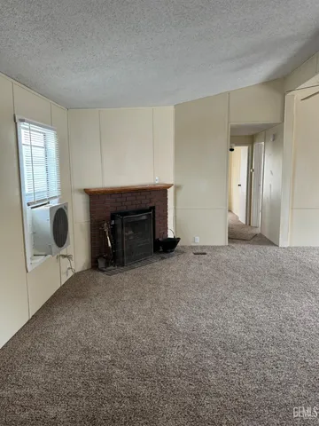 an empty room with furniture and a fireplace