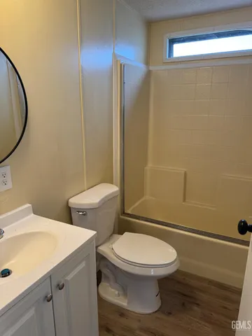 a bathroom with a toilet a sink and shower