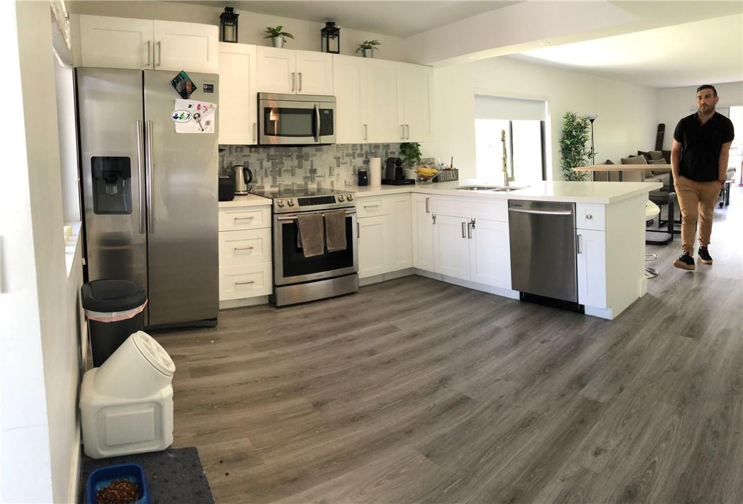 310 Racquet Club Road, Unit 101 Weston, FL 33326 - Photo 1 of 31 a kitchen with stainless steel appliances a stove top oven a sink a counter space and cabinets