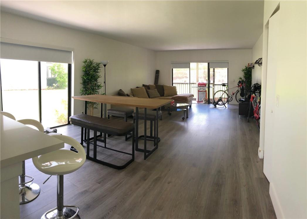 310 Racquet Club Road, Unit 101 Weston, FL 33326 - Photo 18 of 31 a living room with furniture and a wooden floor