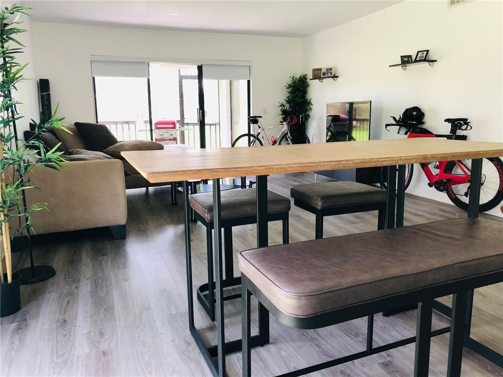310 Racquet Club Road, Unit 101 Weston, FL 33326 - Photo 24 of 31 a view of a dining room with furniture and wooden floor