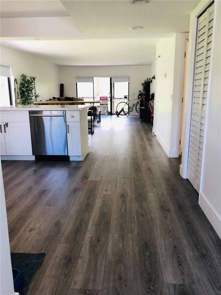 310 Racquet Club Road, Unit 101 Weston, FL 33326 - Photo 8 of 31 a view of a kitchen with furniture and wooden floor