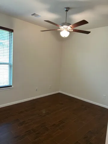 a view of a chandelier fan and hardwood floor