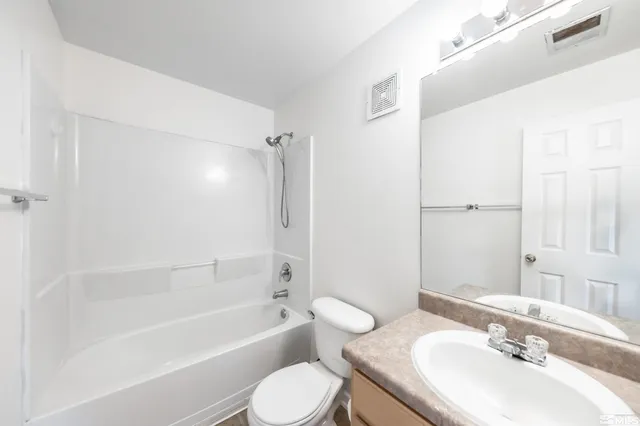 a bathroom with a sink toilet tub vanity and shower
