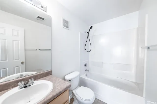 a bathroom with a sink toilet tub and shower
