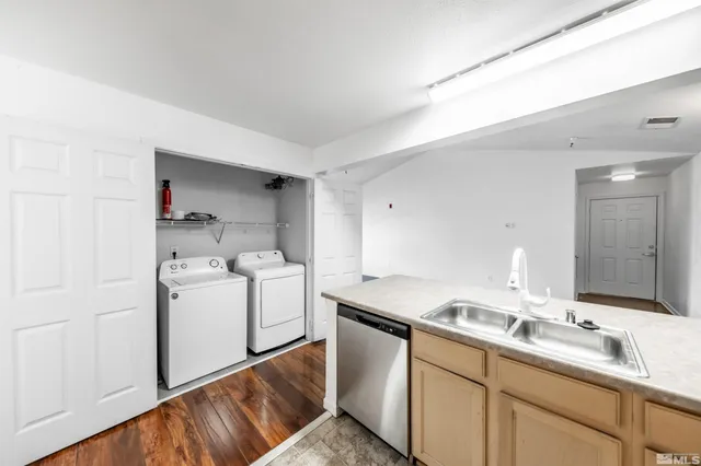 a room with a sink and a washer dryer