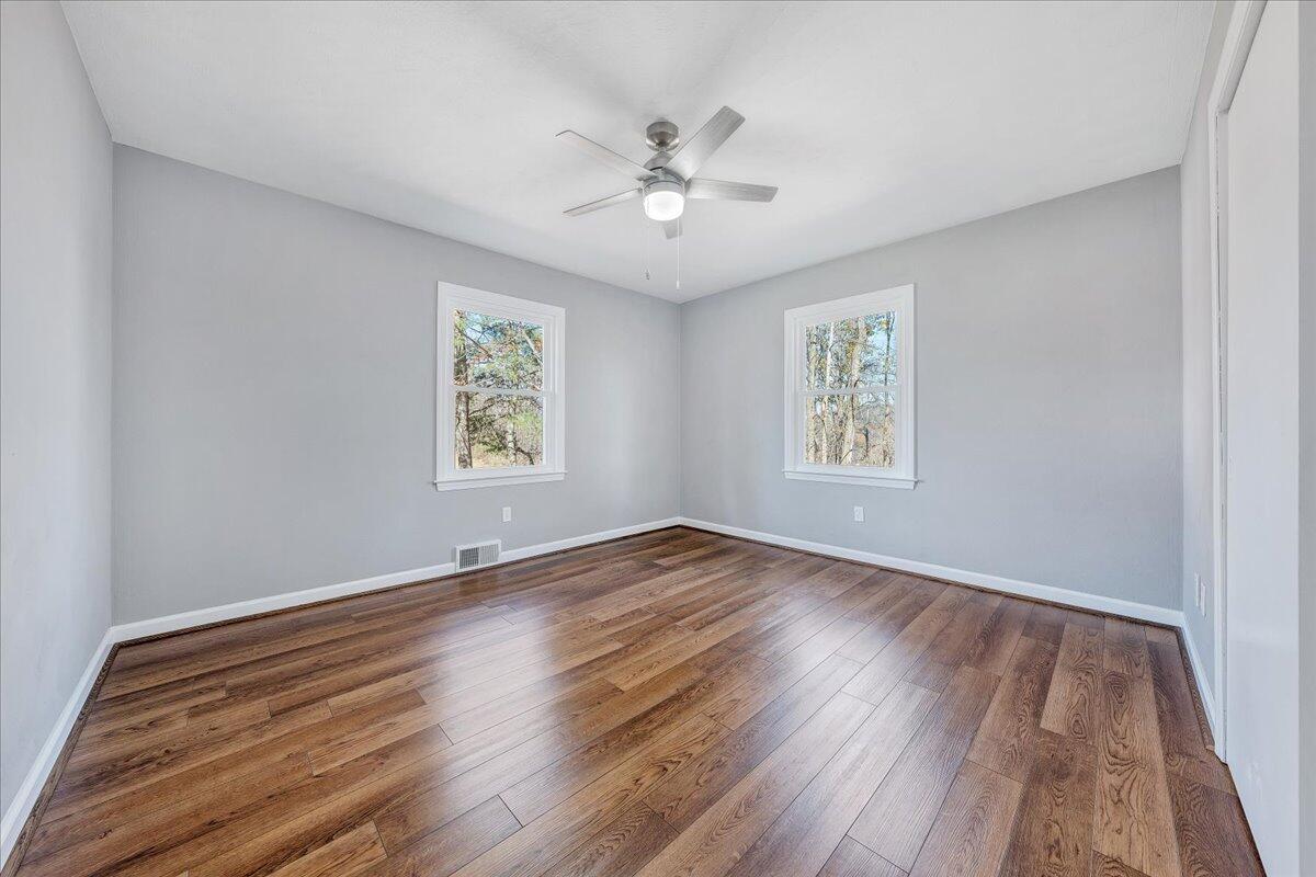 2353 Thompson Ridge Road Ferrum, VA 24088 - Photo 23 of 46 a view of an empty room with wooden floor and a window
