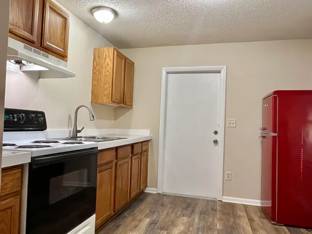 a view of a kitchen with a sink and cabinets