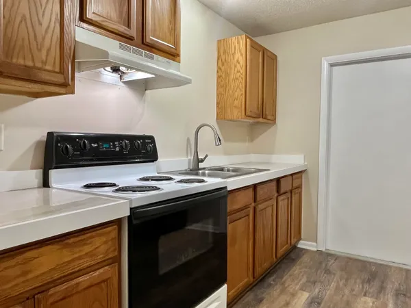 a kitchen with stainless steel appliances a stove and a sink