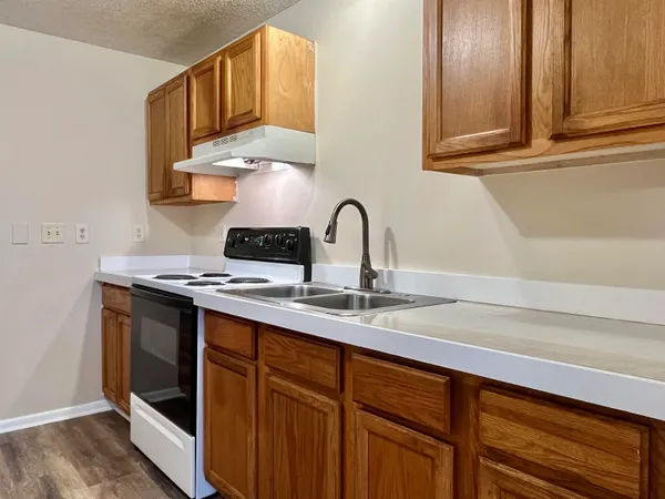a kitchen with a sink stove and cabinets