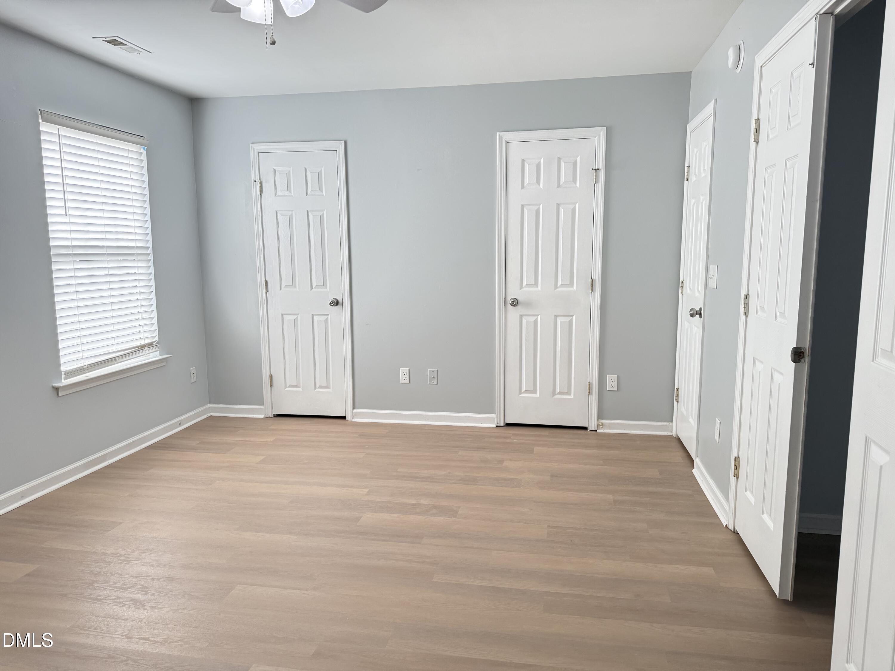 1206 Maroon Drive Durham, NC 27713 - Photo 12 of 20 a view of an empty room with wooden floor and a window