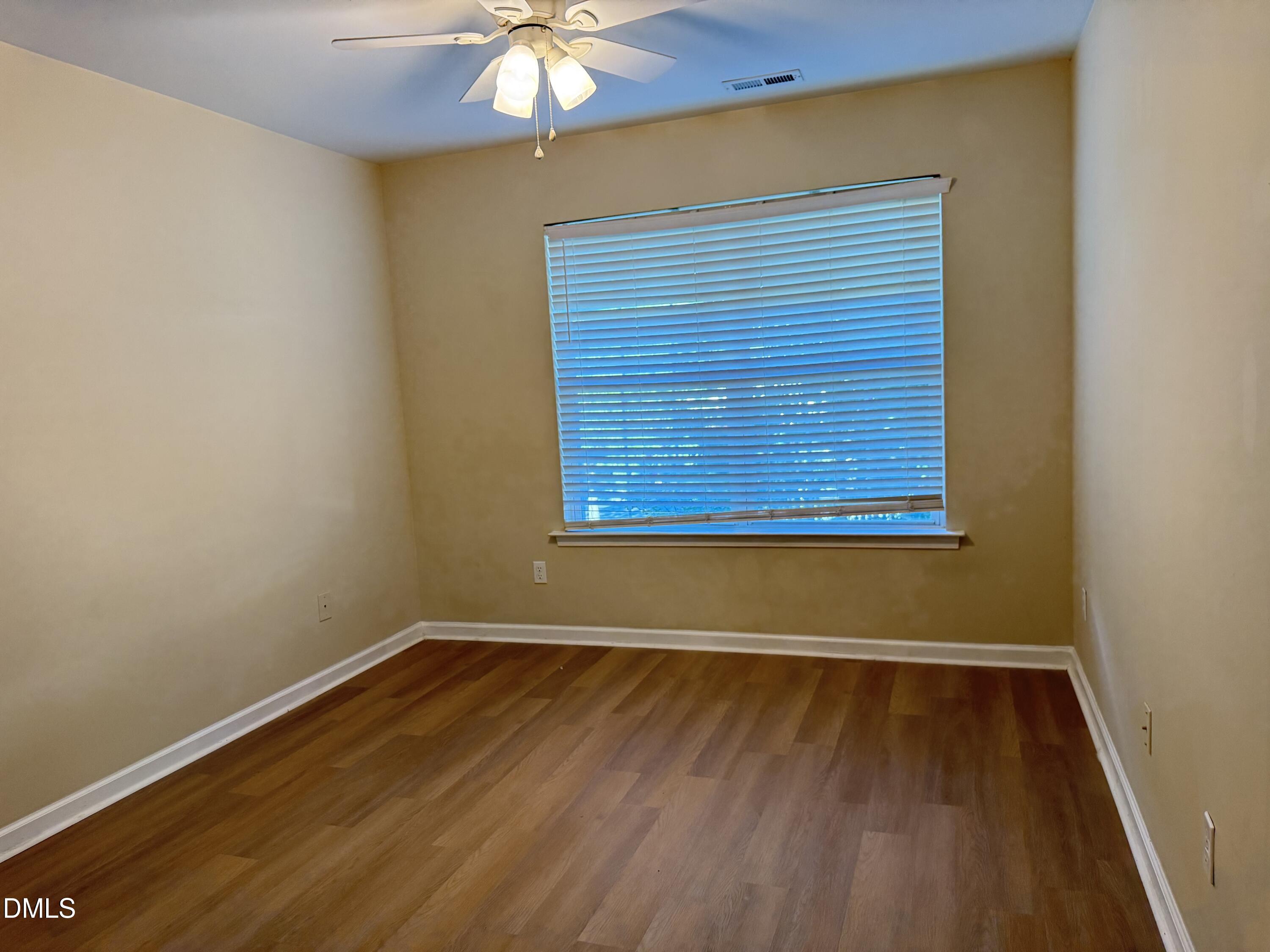 1206 Maroon Drive Durham, NC 27713 - Photo 13 of 20 an empty room with wooden floor and windows