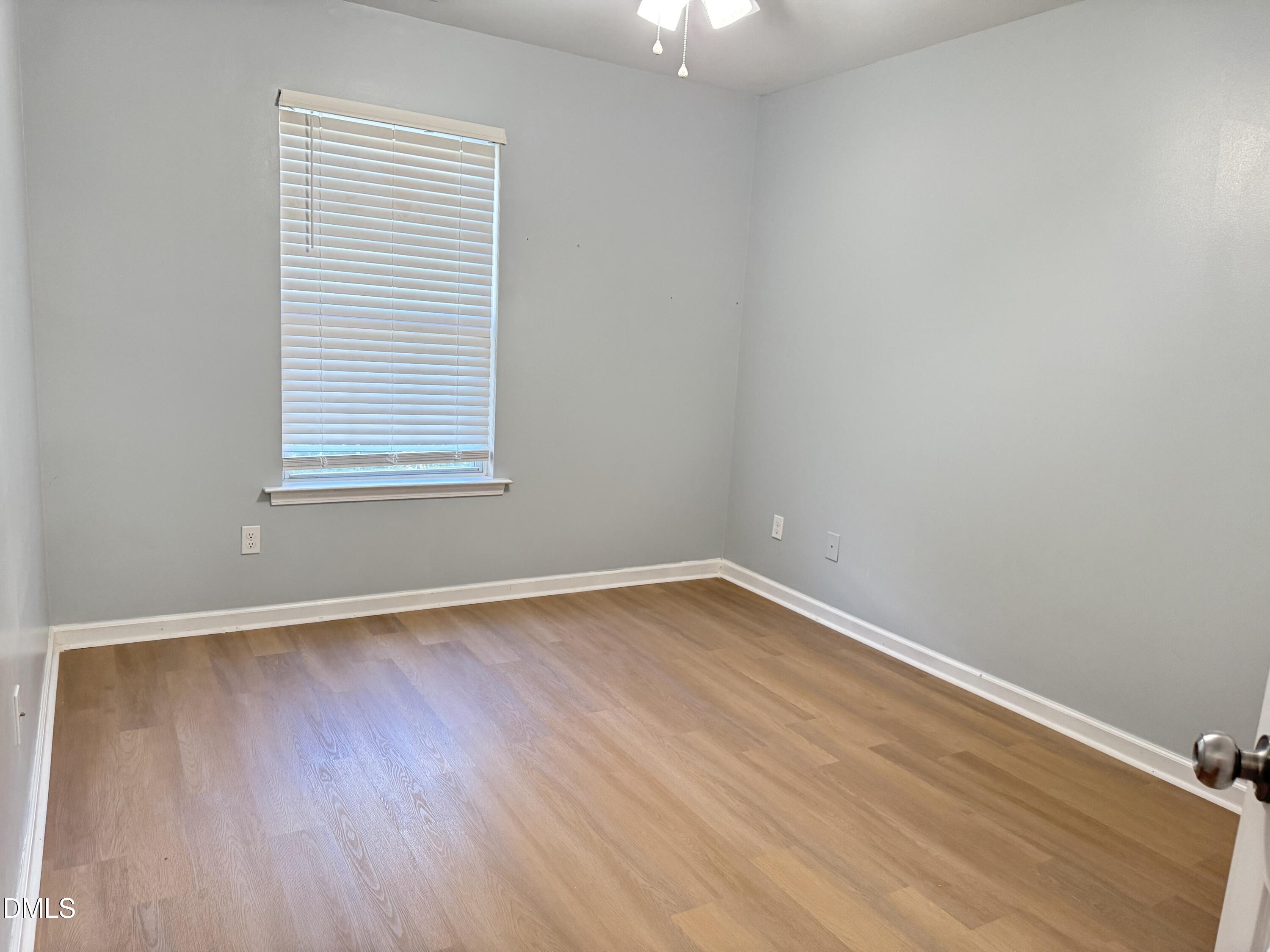1206 Maroon Drive Durham, NC 27713 - Photo 15 of 20 an empty room with wooden floor and windows