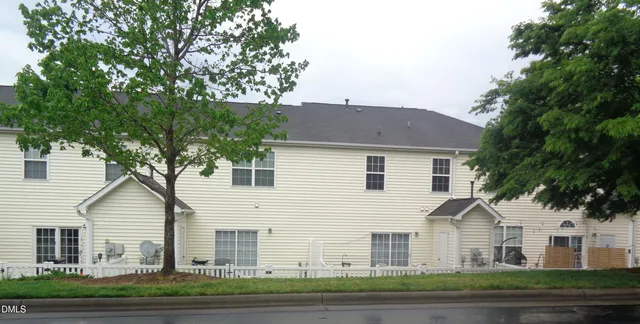 a view of house with a yard