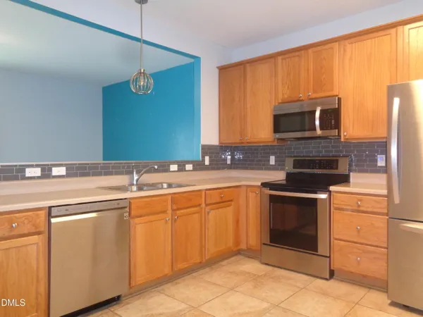 a kitchen with a sink stove and microwave
