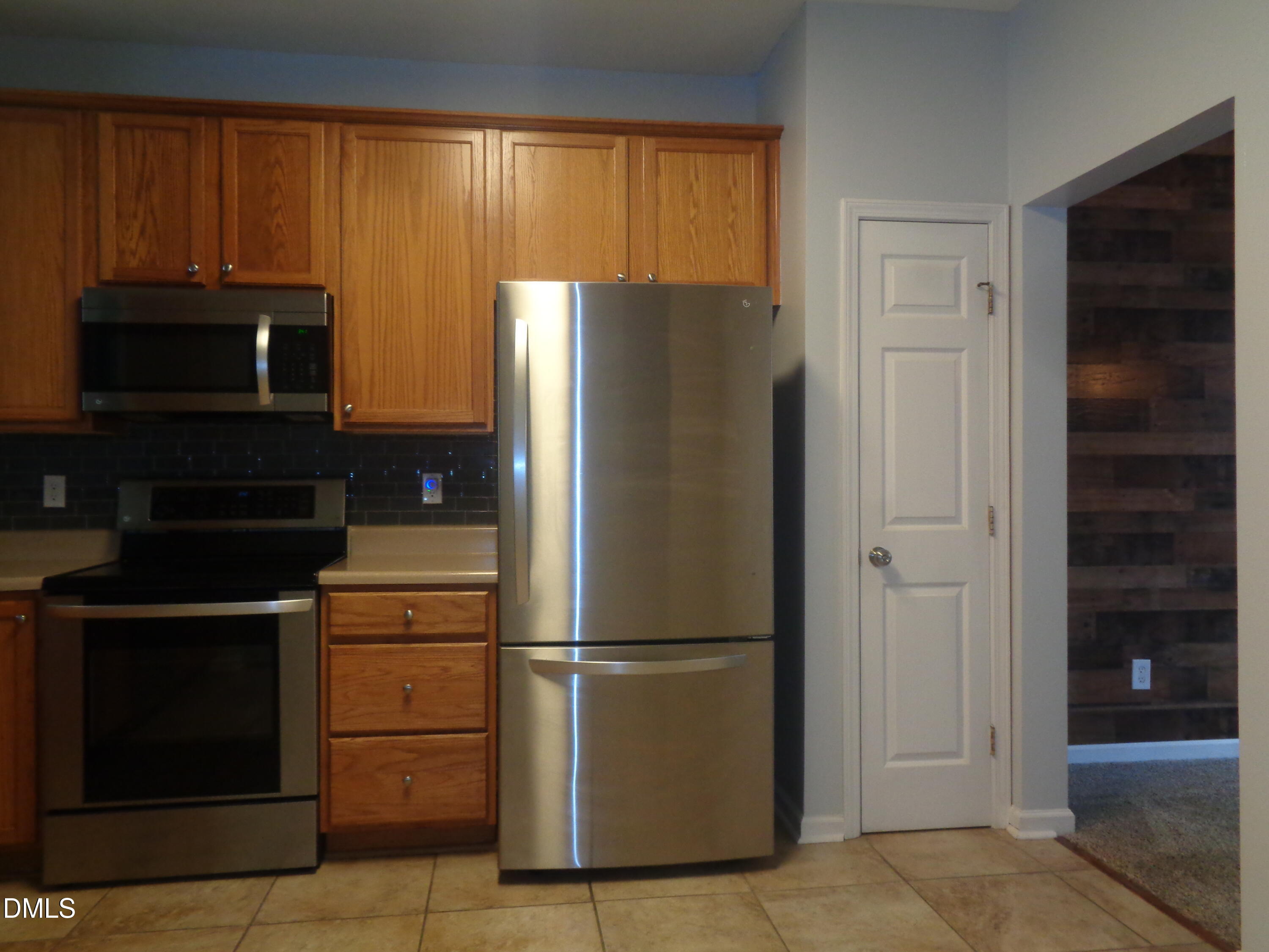 1206 Maroon Drive Durham, NC 27713 - Photo 8 of 20 a metallic refrigerator freezer sitting in a kitchen
