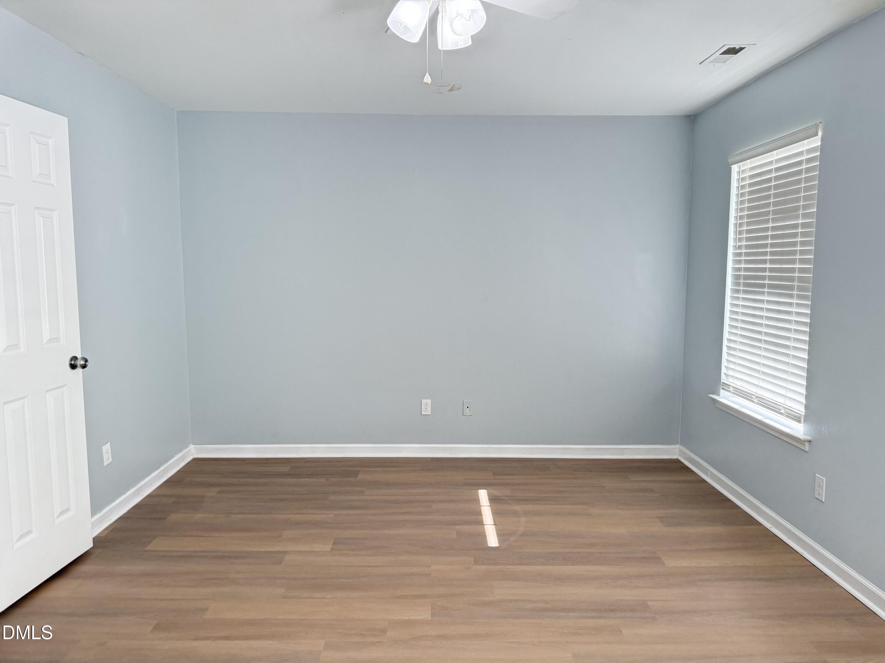 1206 Maroon Drive Durham, NC 27713 - Photo 10 of 20 an empty room with wooden floor and windows