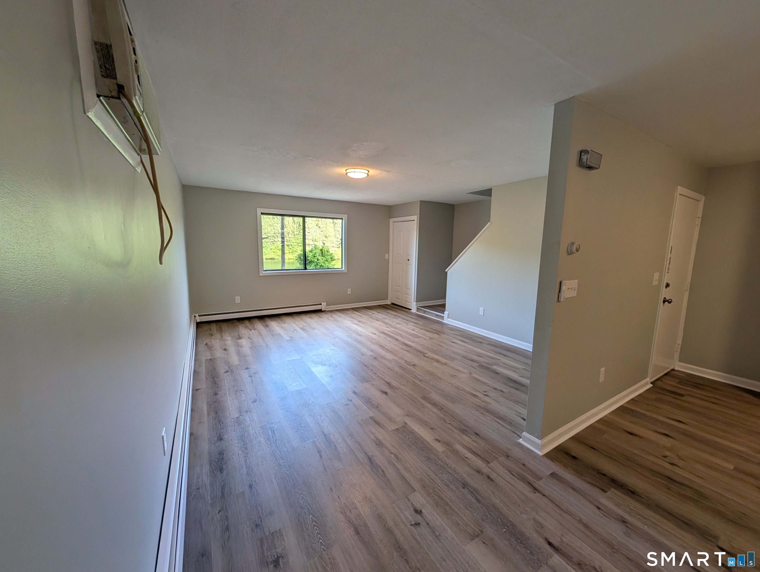 267 Beaver Street Ansonia, CT 06401 - Photo 4 of 12 an empty room with wooden floor and windows