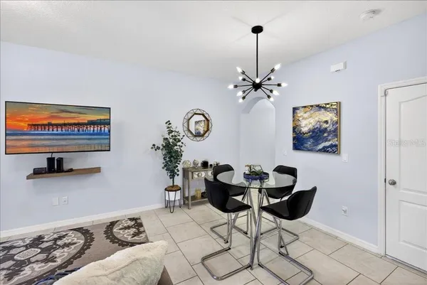 a view of a bedroom with furniture and chandelier
