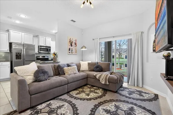 a living room with furniture ceiling fan and a rug