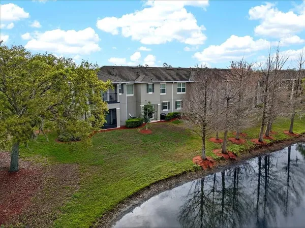 a view of a house with backyard and sitting area