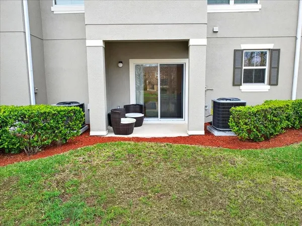a view of a house with backyard sitting area and garden