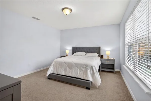 a bedroom with a bed and a window