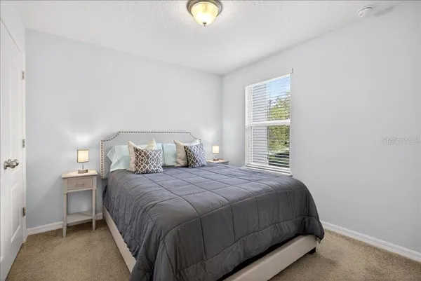 a bedroom with a bed and window