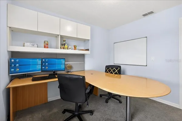 a view of a workspace with furniture