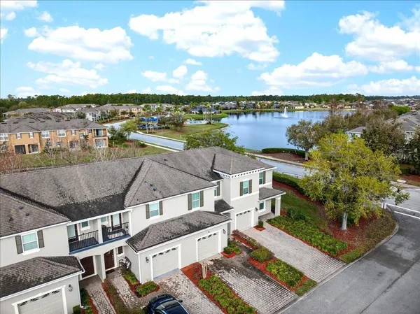 an aerial view of a house with a garden and lake view