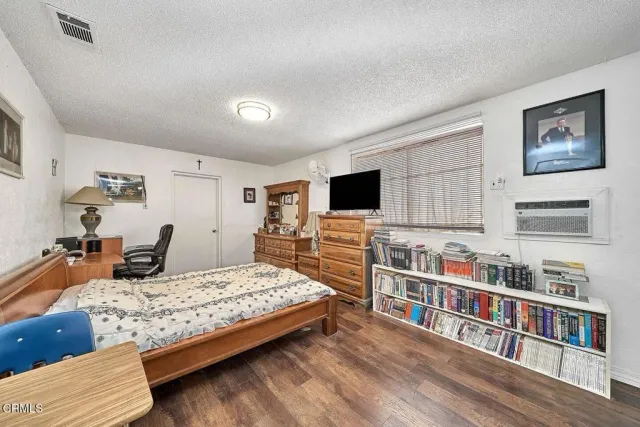 a bedroom with furniture and a flat screen tv