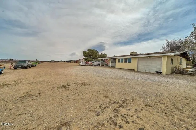 a view of a house with a parking space and a car parked in it