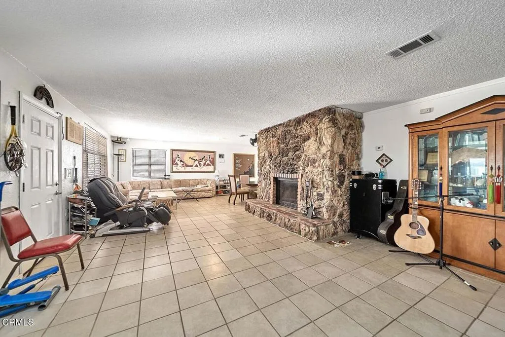 9125 Mesa Road Lucerne Valley, CA 92356 - Photo 6 of 55 a living room with furniture a fireplace and flat screen tv