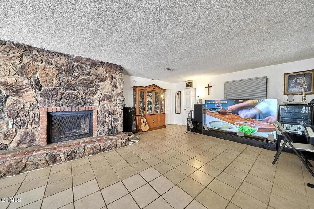 9125 Mesa Road Lucerne Valley, CA 92356 - Photo 7 of 55 a bed room with a bed and a fireplace