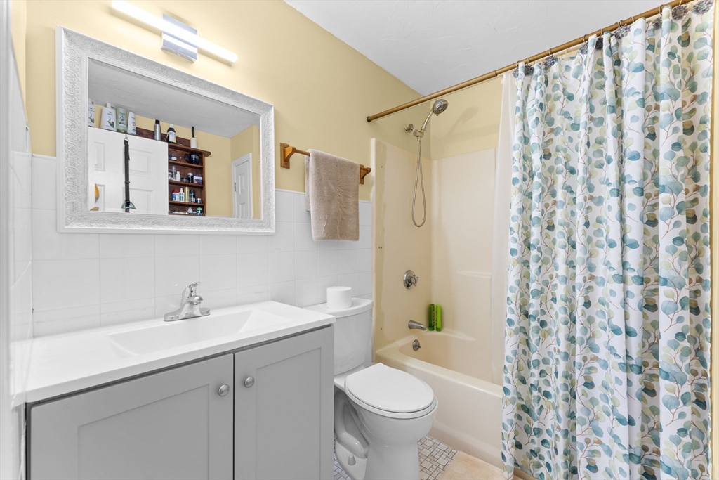 902 Irving Road, Unit 902 Randolph, MA 02368 - Photo 19 of 22 a bathroom with a sink toilet and shower