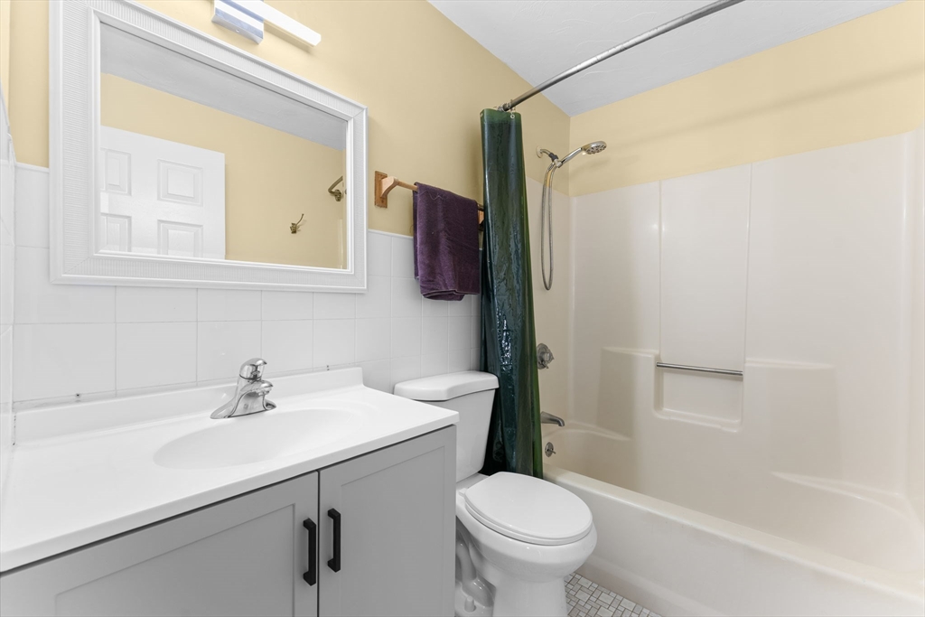 902 Irving Road, Unit 902 Randolph, MA 02368 - Photo 20 of 22 a bathroom with a sink a toilet and shower